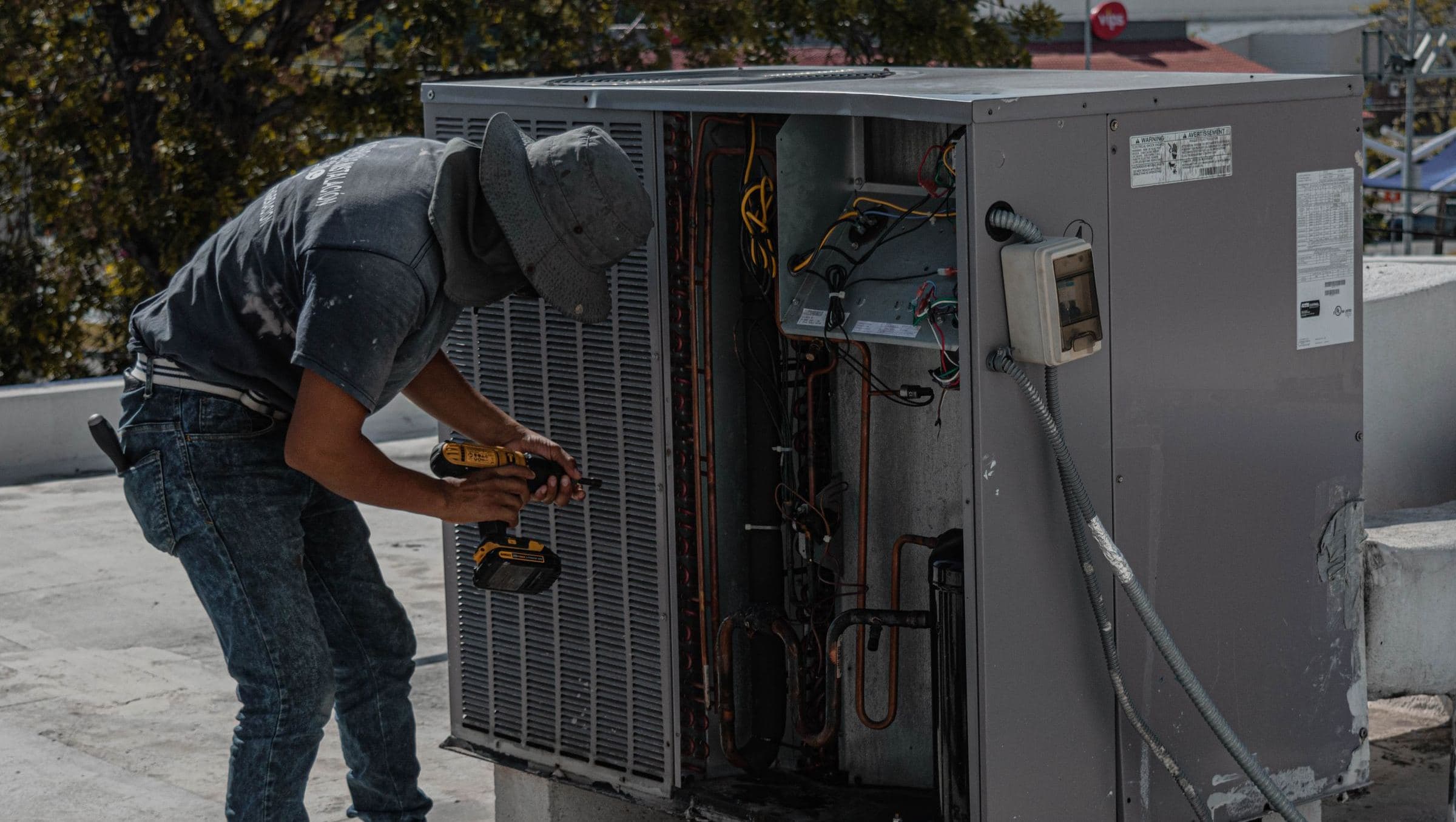 HVAC technician servicing a rooftop unit